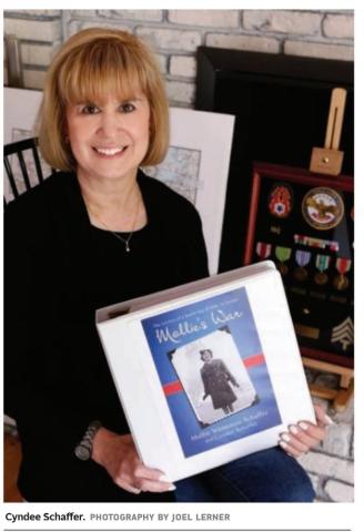 Author Cyndee Schaffer holding her book "Mollie's War"
