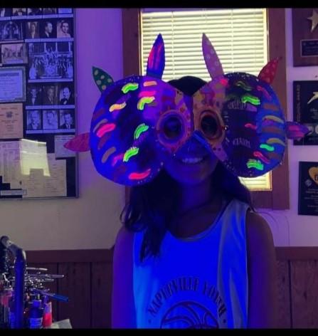 Girl wearing completed Alibrije mask under blacklight 